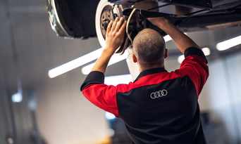 View of vehicle technician checking tire pressure