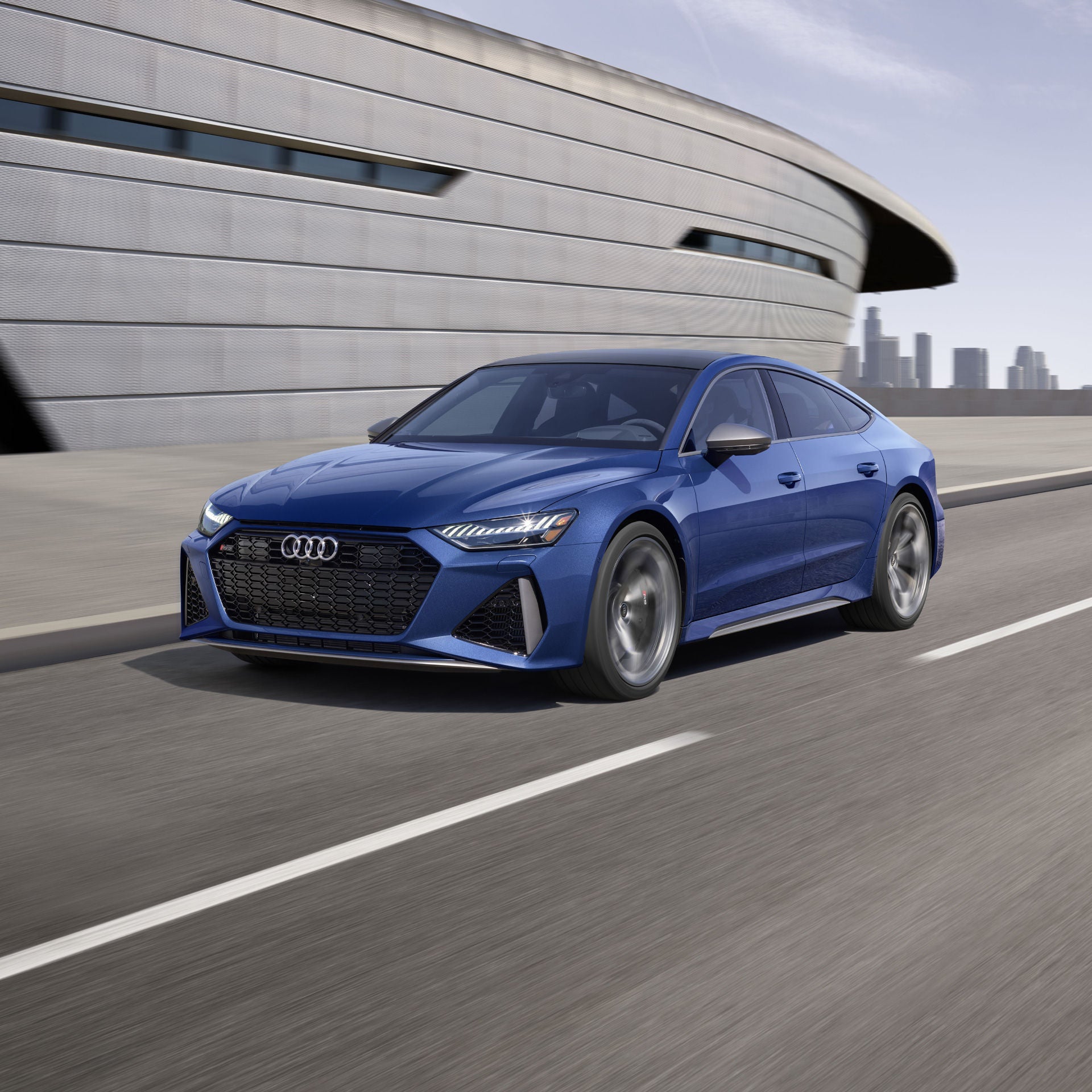 Three-quarter side view of the Audi RS 7 in motion.