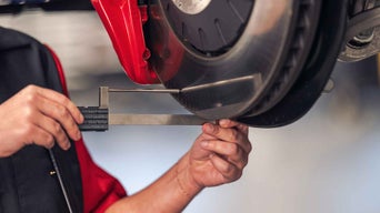 Service technician servicing tire.