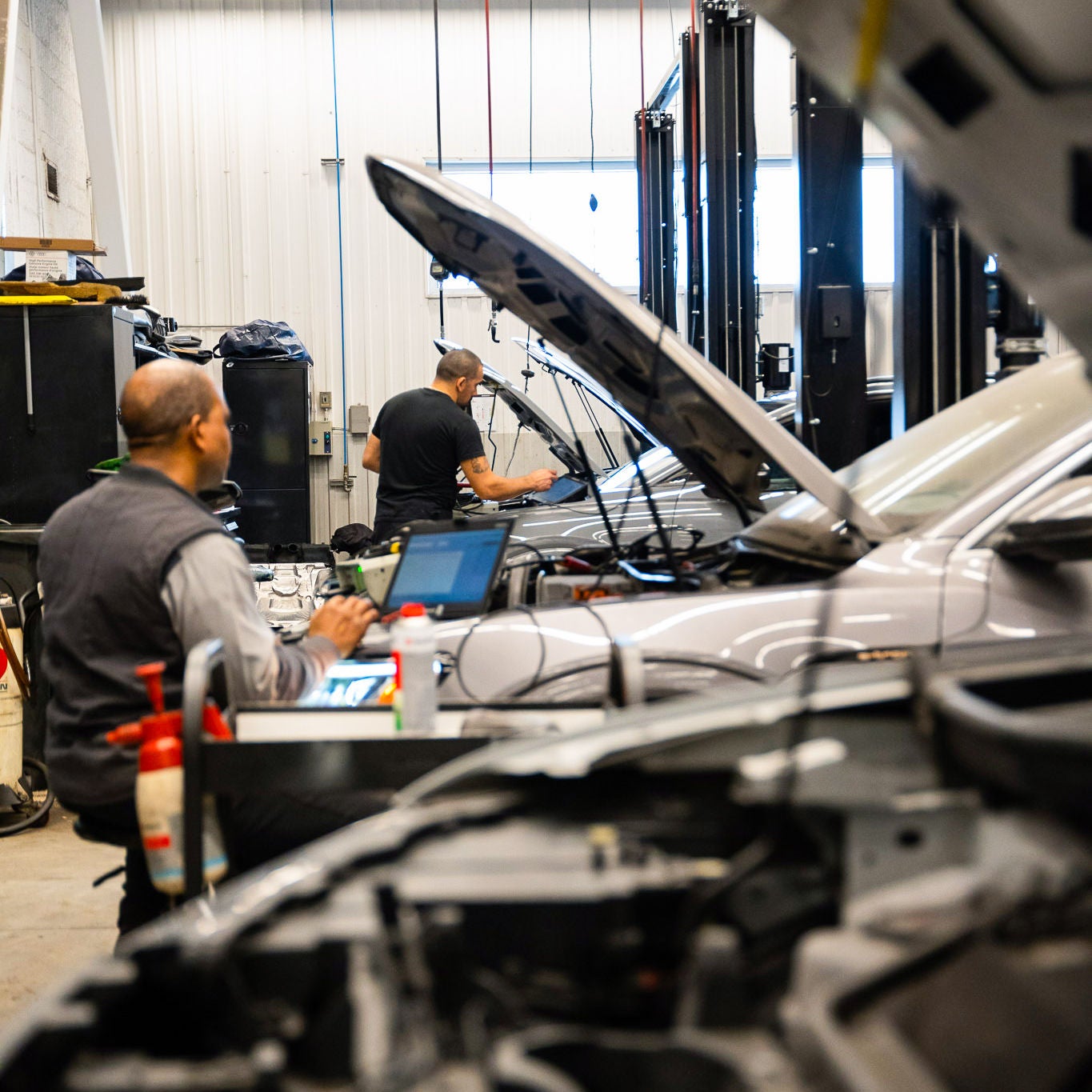 Audi service technician servicing a vehicle.
