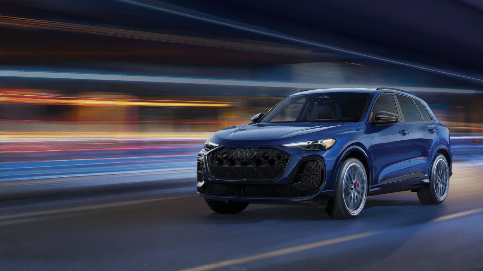 Audi SUV flashing by the road