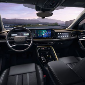 View of the interior cabin, showing the dash and front seats, of the Audi Q5 Sportback.