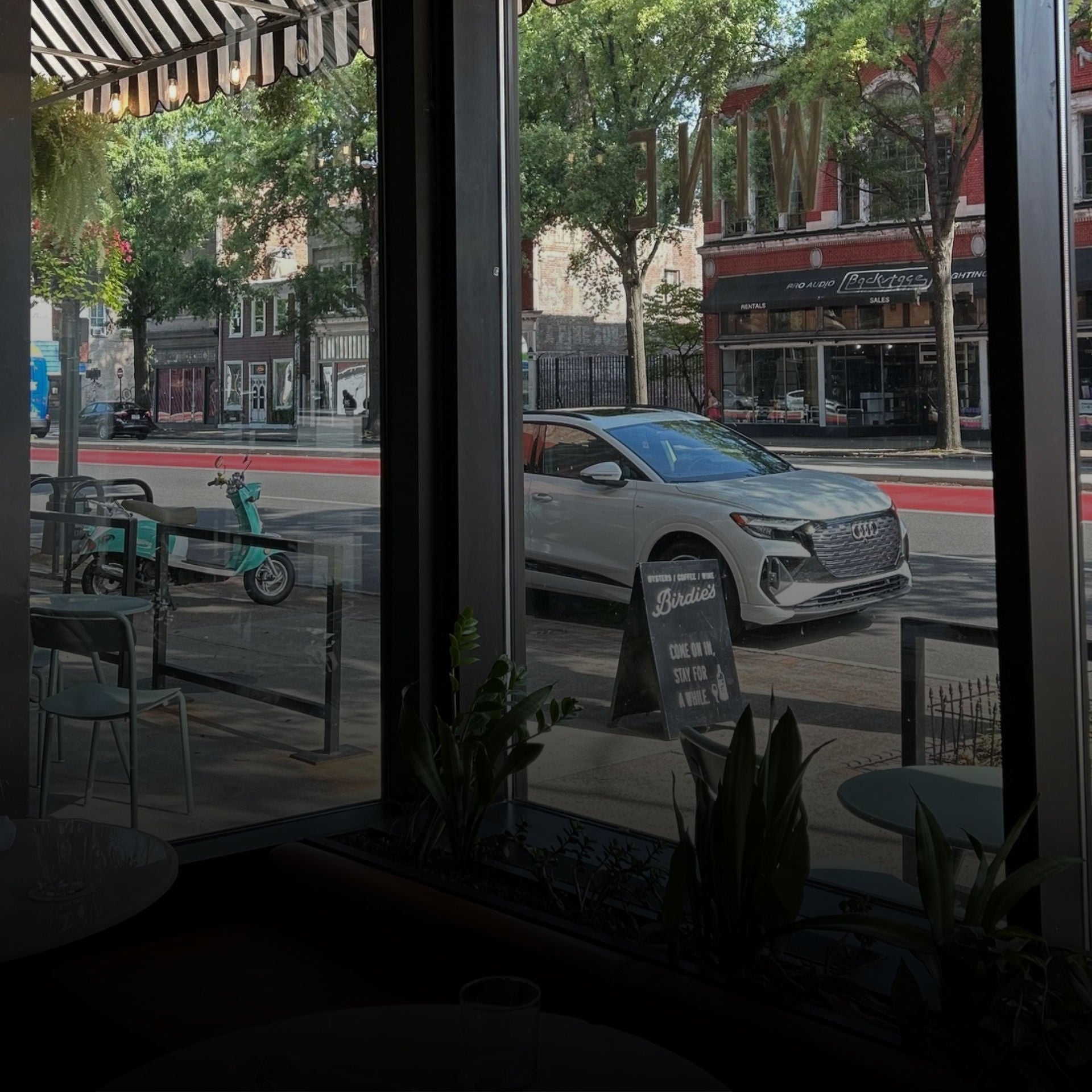 Front view of a white Audi SUV parked on the side of a street.