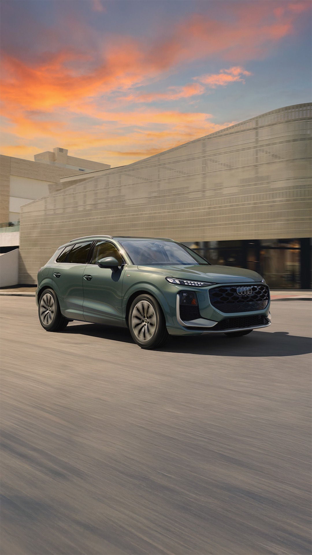 All new 2026 Audi Q3 dimensions driving past a modern building in Sacramento.