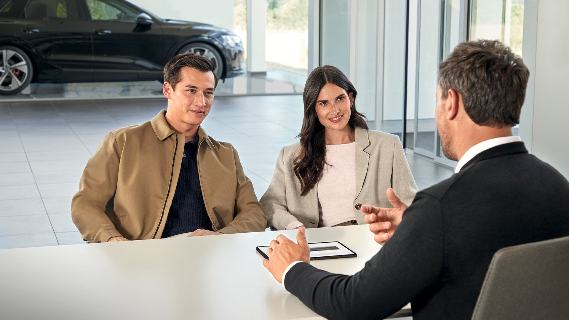 An Audi service advisor and customers