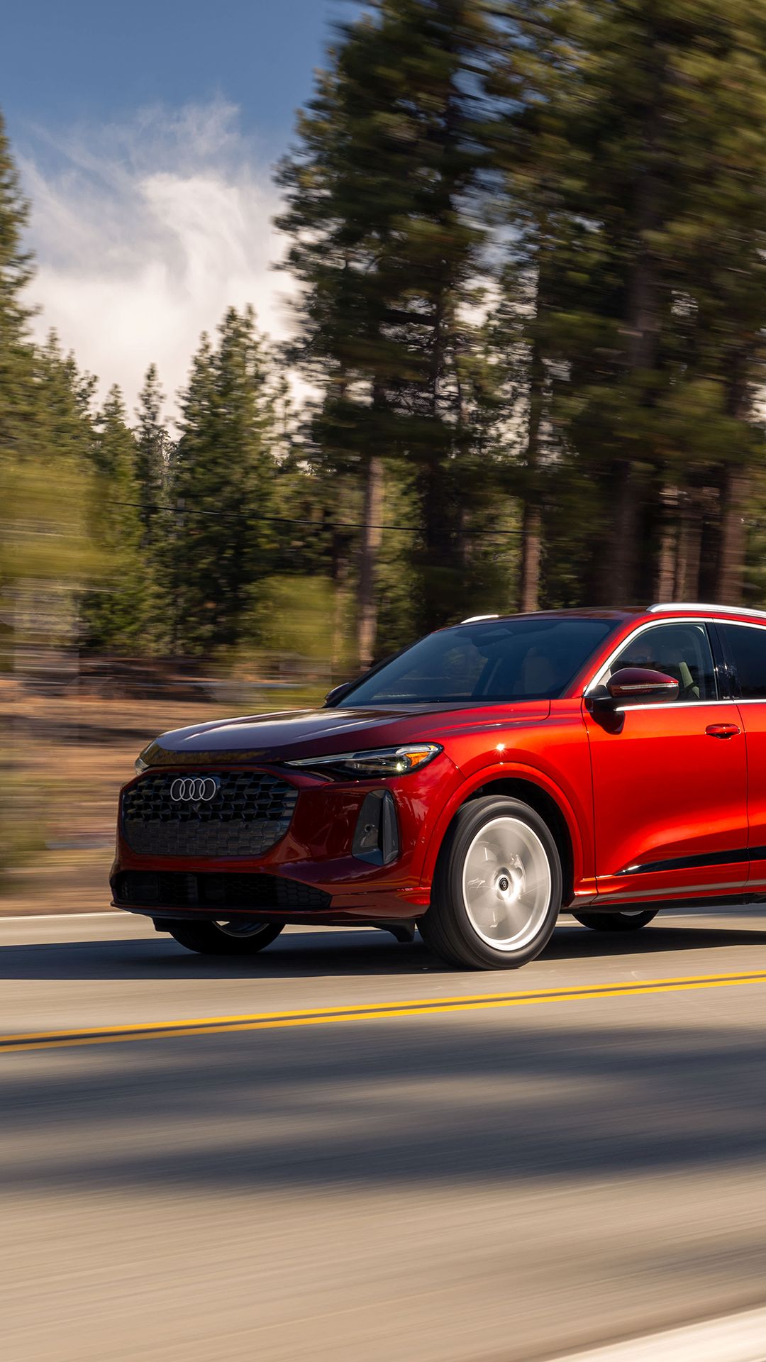 Three quarter profile view of an Audi Q5 accelerating.