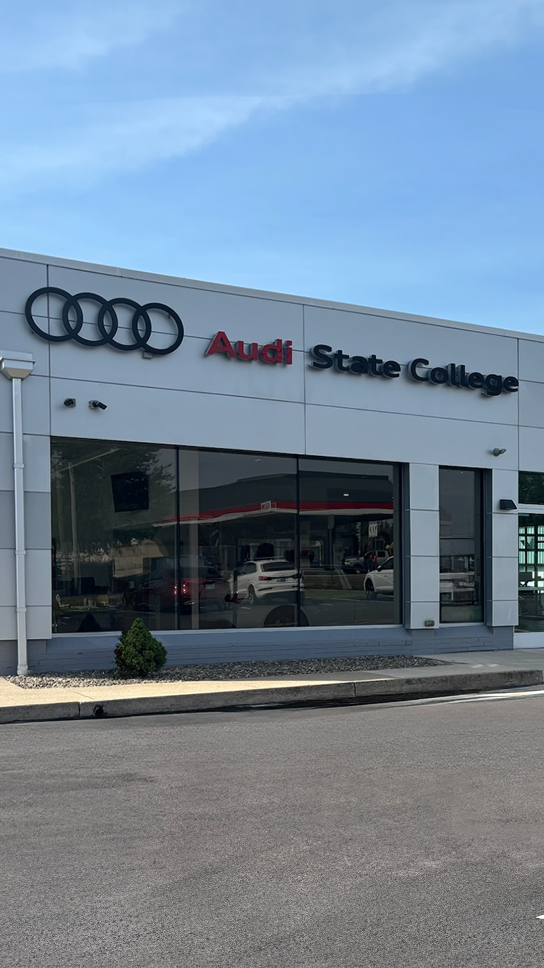 Front view of Audi vehicles parked in front of the Audi State College dealership