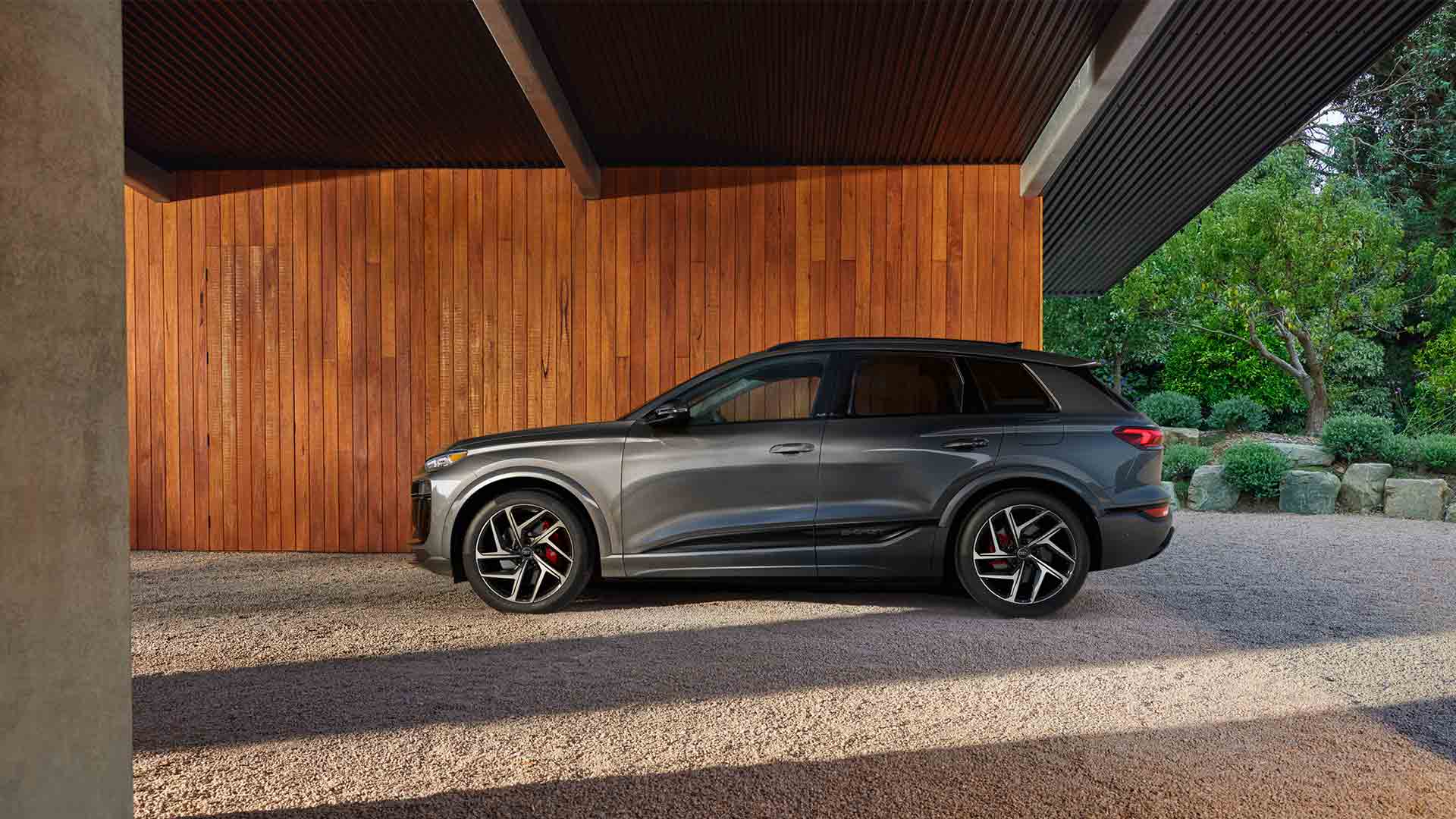 Side profile view of an Audi Q6 e-tron parked.