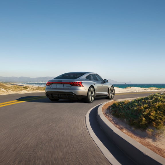 Rear view of the Audi S e-tron GT in motion.