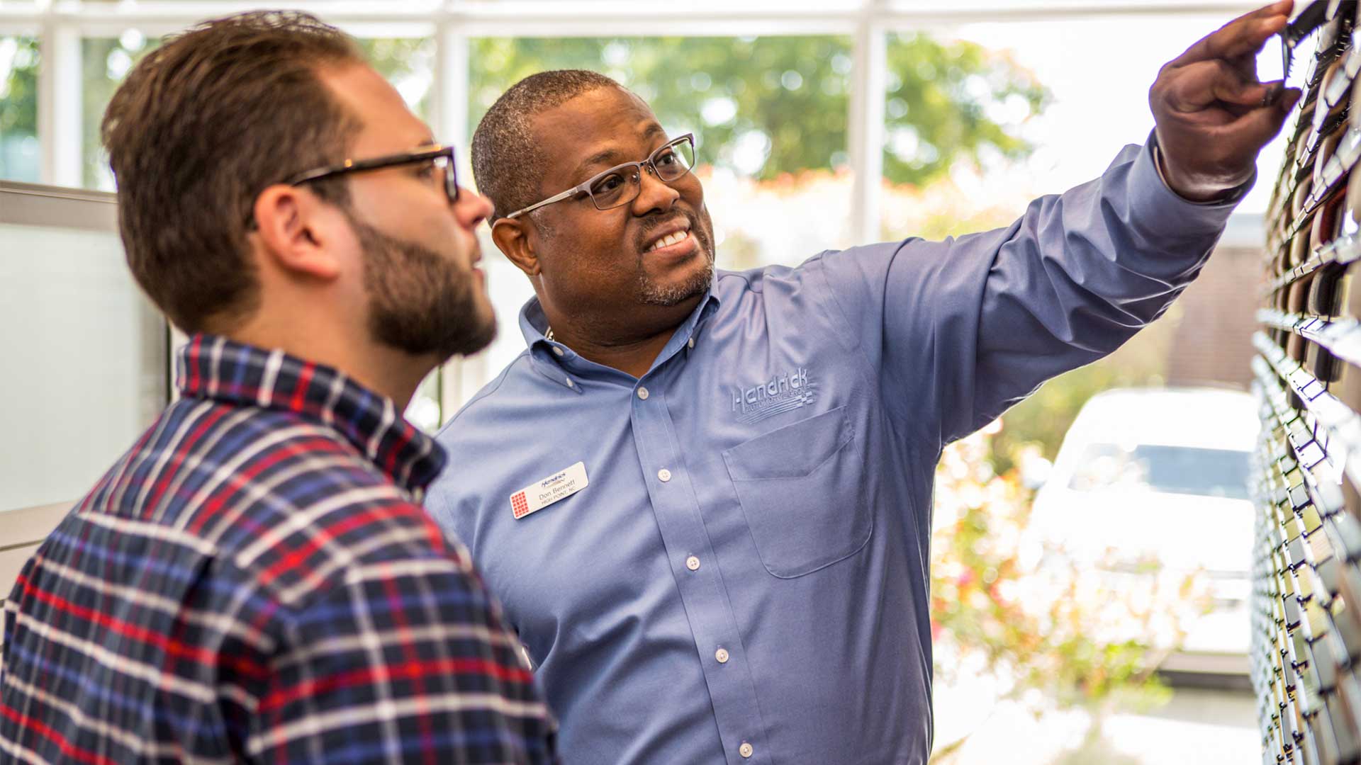 Audi Sale Specialist explaining vehicle features to a customer.