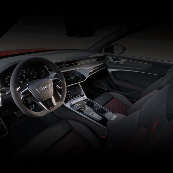 Interior view of the Audi RS 6 Avant performance dashboard and seats.