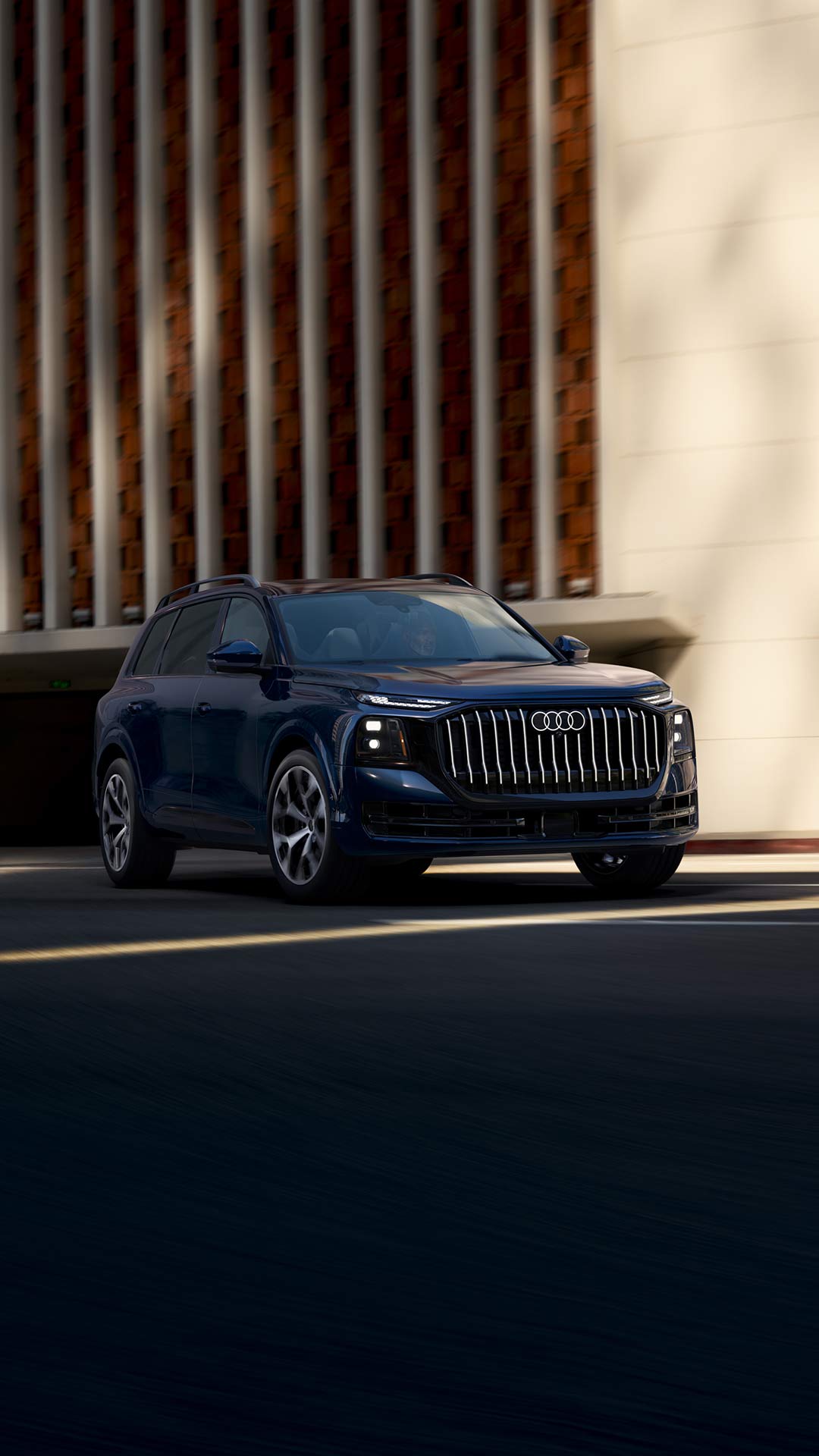 3/4 far view of an Audi Q9 parked in front of a modern building.