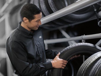 Service technician servicing tire.