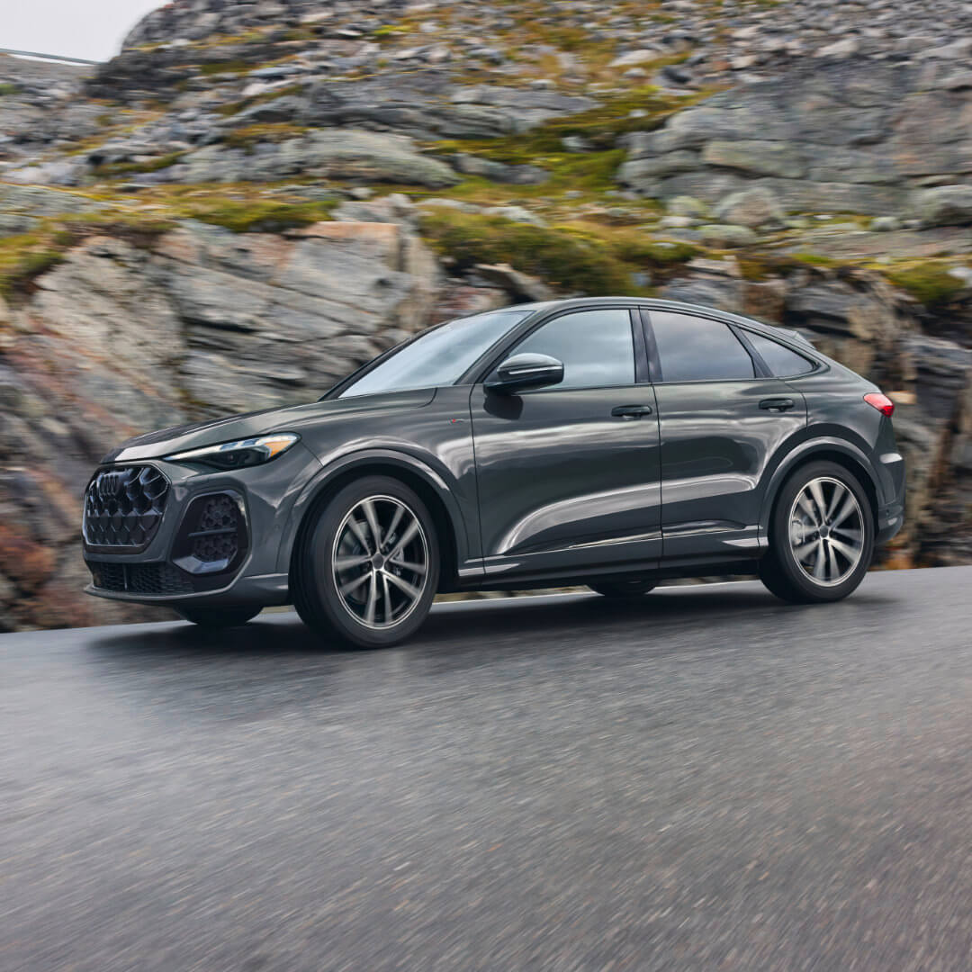 2026 Audi Q5 Sportback Exterior Driving Past Rock Wall