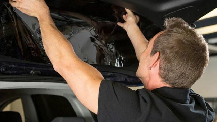 Audi mechanic inspecting vehicle damage in the collision repair shop