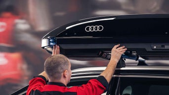Service technician attaching roof storage on Audi 