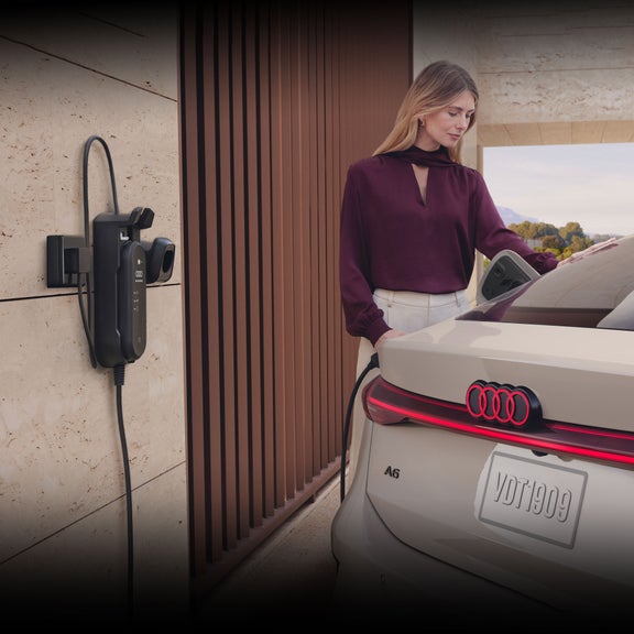 Close-up on a person charging the Audi A6 e-tron. 