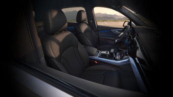 Interior cabin of the 2025 Audi Q7 featuring its digital cockpit, luxury leather seating, and MMI touchscreen system.