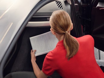 Service technician serving vehicle.