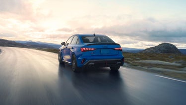 Rear view of the Audi RS 3 accelerating on a highway.