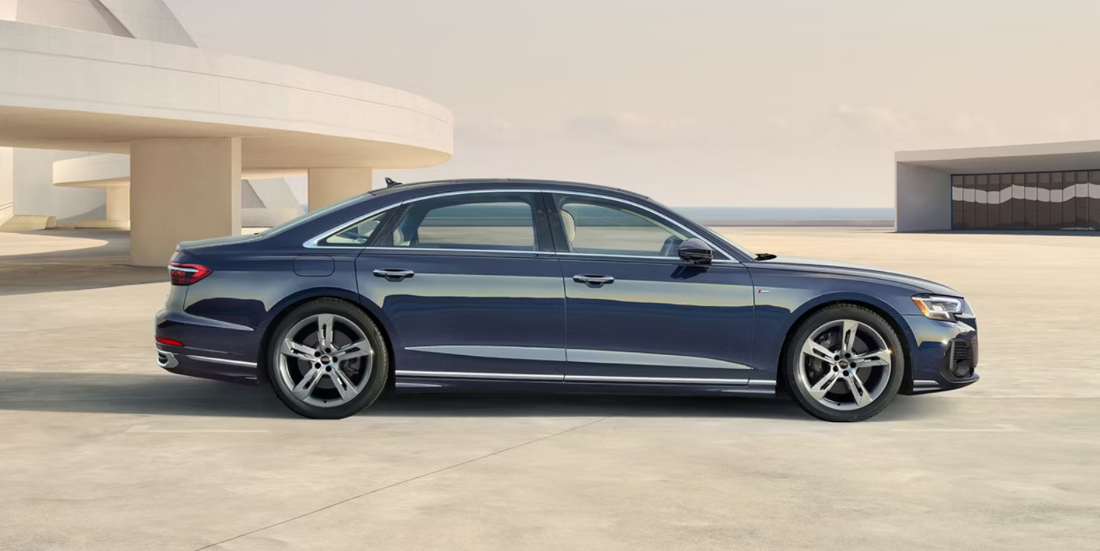 Side profile view of an Audi A8 parked.