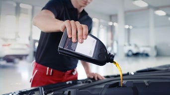 Service technician changing oil.