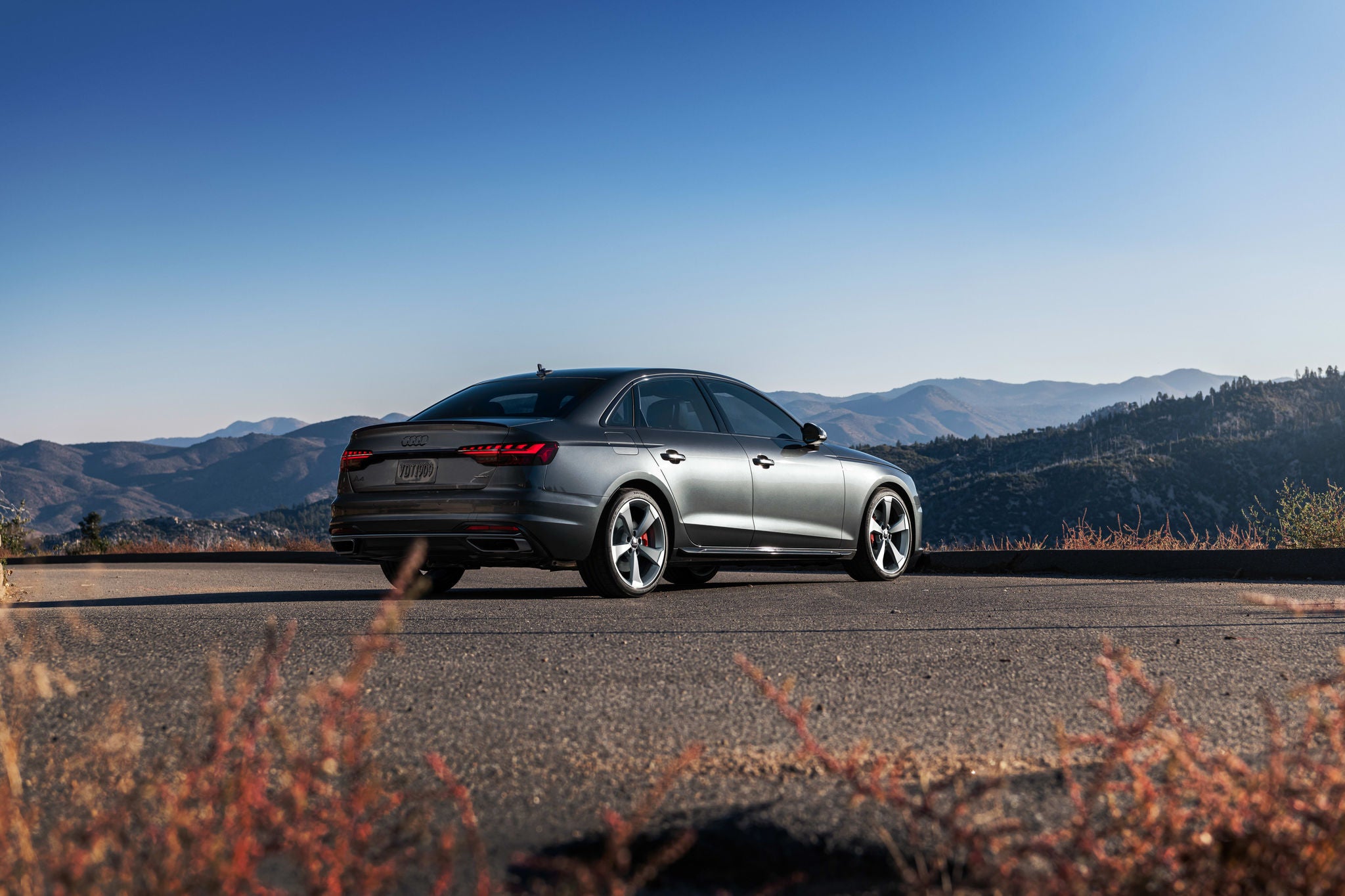 CPO Audi sedan parking outdoor with mountains in background