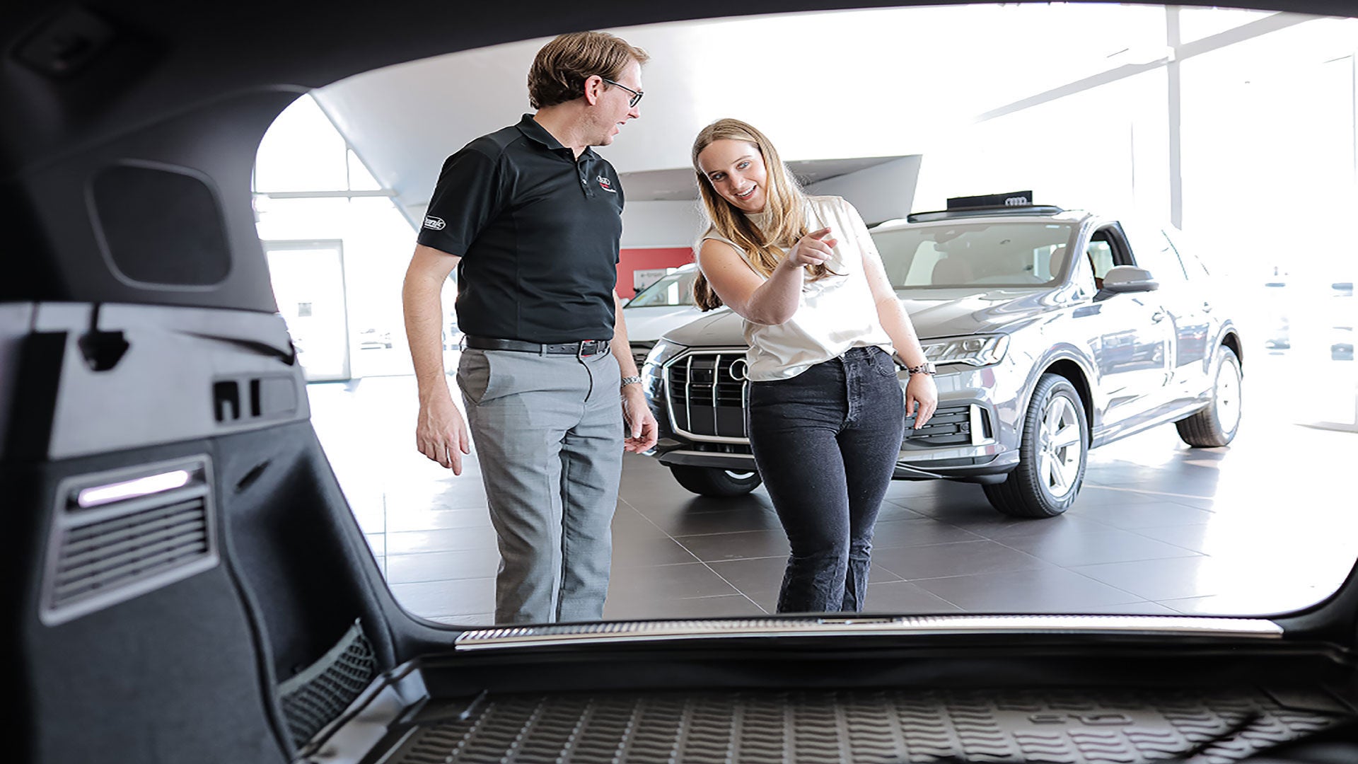Audi employee with a customer in a showroom.