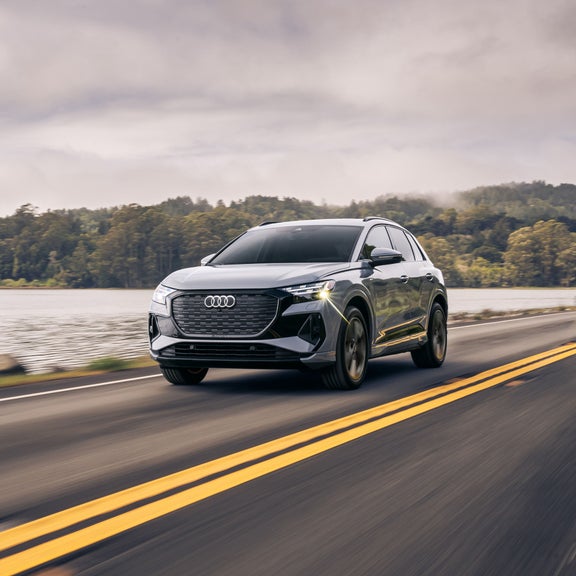 Three-quarter front profile of the Q4 e-tron in motion.
