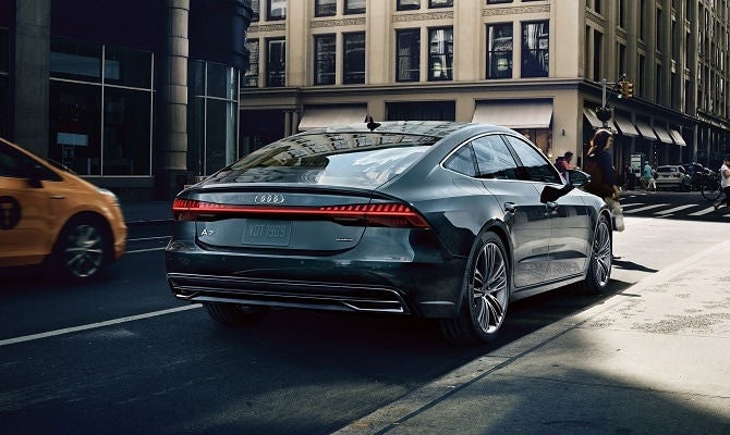 Audi A7 driving through s mid city street