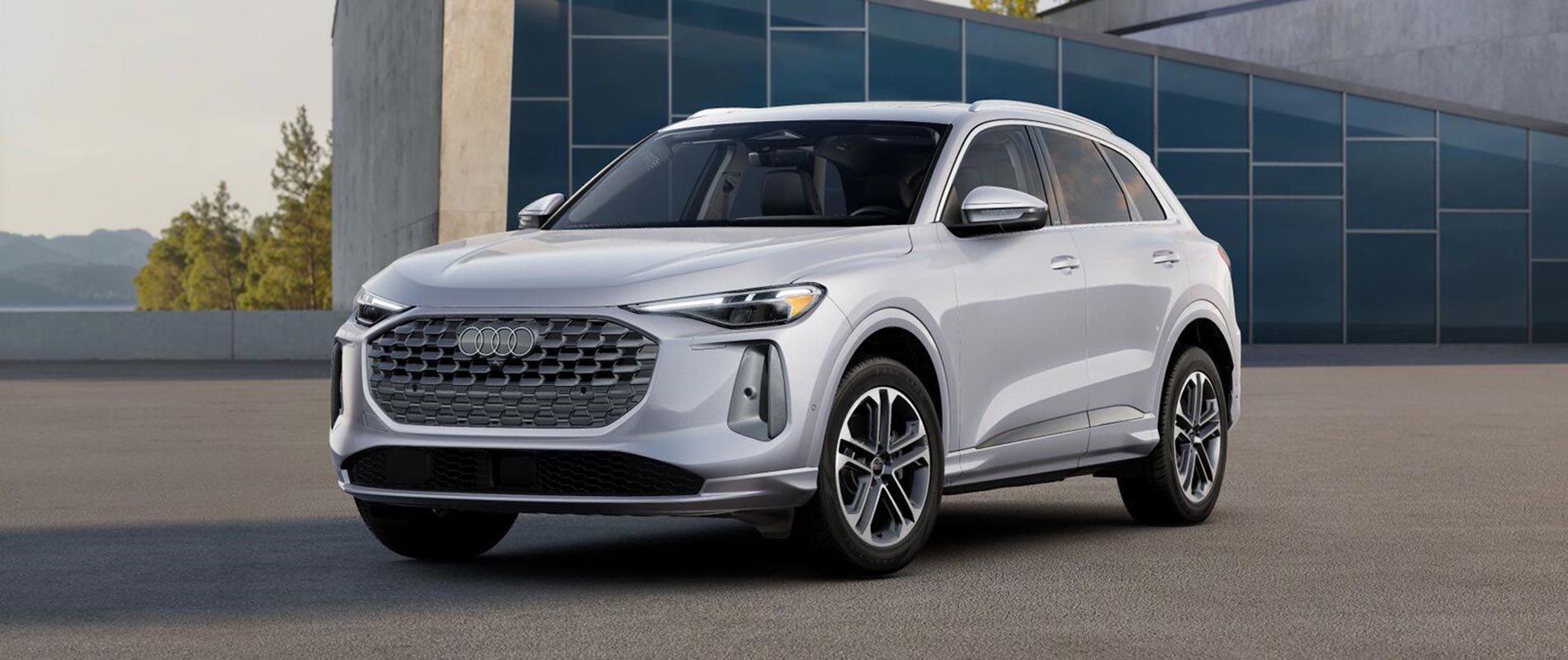 2025 Audi Q5 parked in front of a blue wall