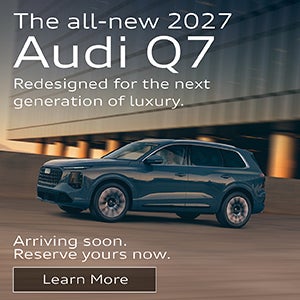 Side view of an Audi Q7 driving.