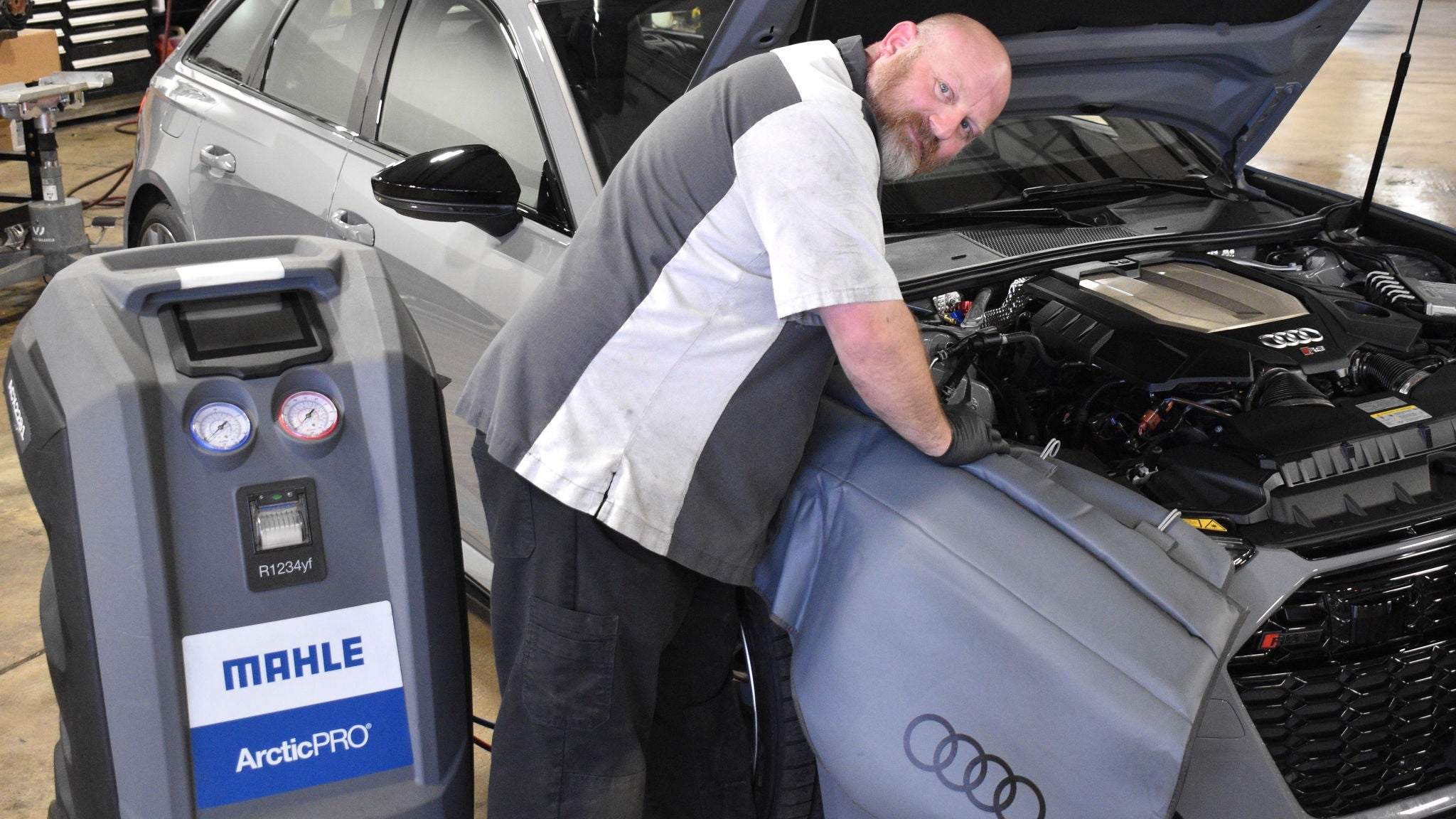 Audi service technician servicing a vehicle.