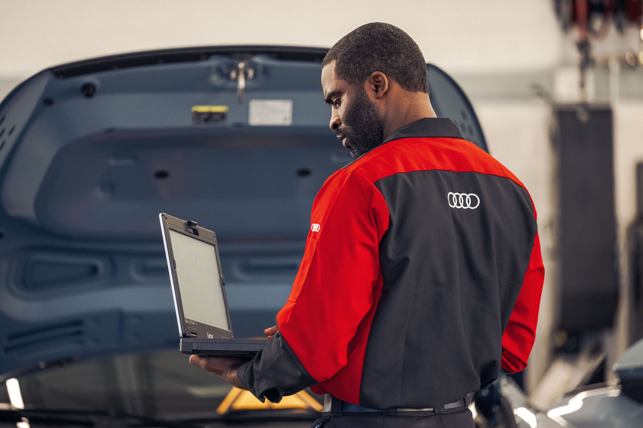 Audi Service Advisor working on a computer.