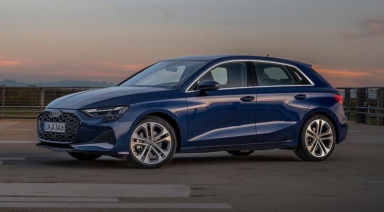 Side profile view of an Audi parked.