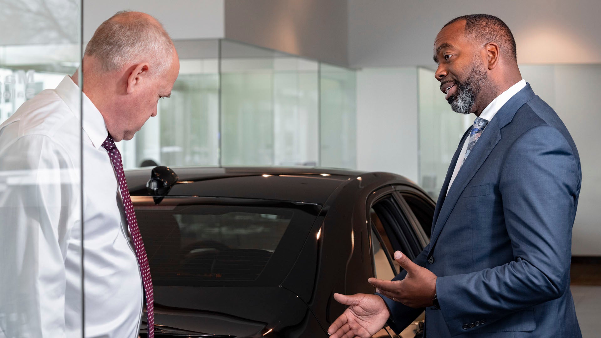 Audi Sales Associate helping a customer choose new vehicle customization options.