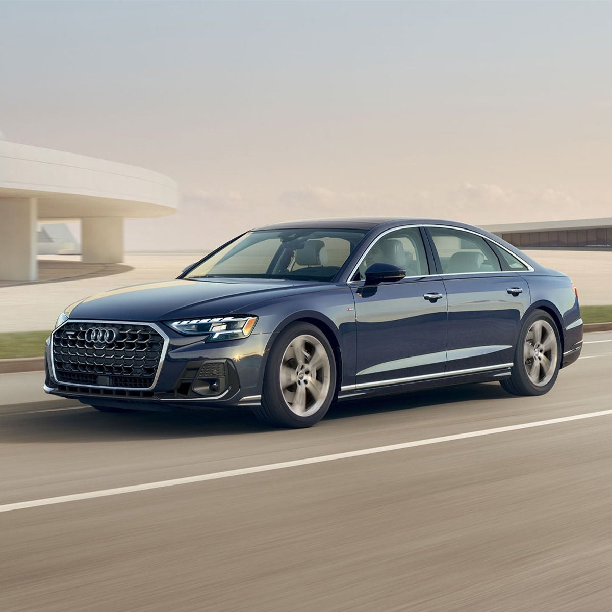 Three quarter front profile of the Audi A8 accelerating.