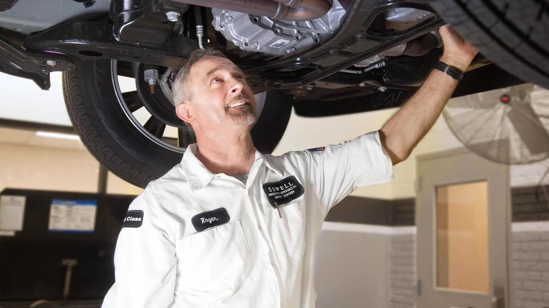 Audi service technician servicing a vehicle.