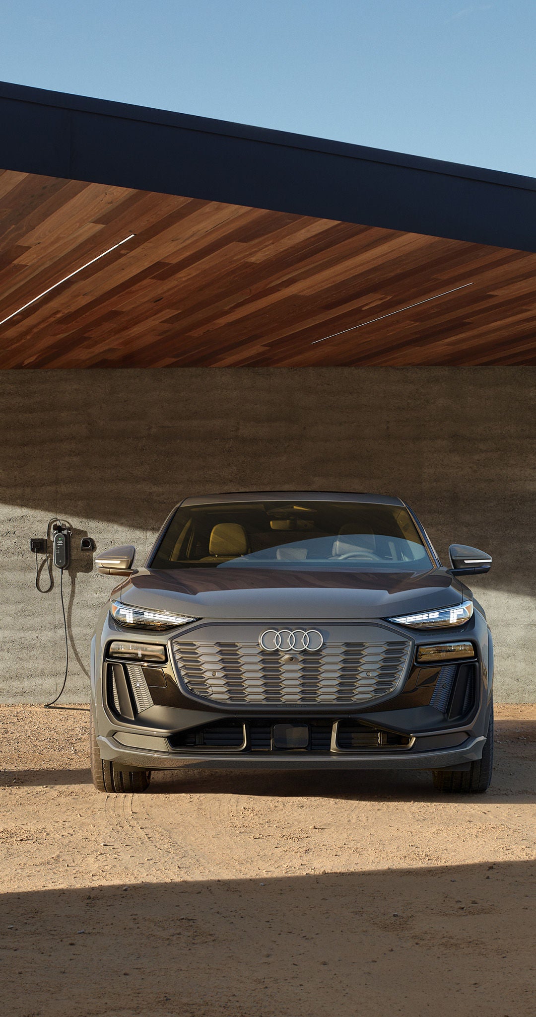Audi lease deals and offers shown with an e-tron infront of modern house