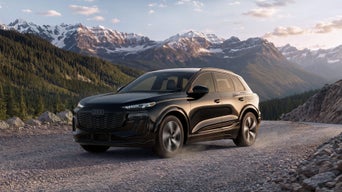 Front profile of an Audi Q6 e-tron accelerating.