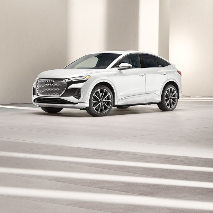 Three-quarter side view of the Audi Q4 Sportback e-tron parked.