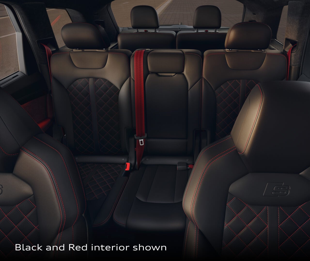 Interior backseat view of the 2026 Audi Q7 showing black and red leather