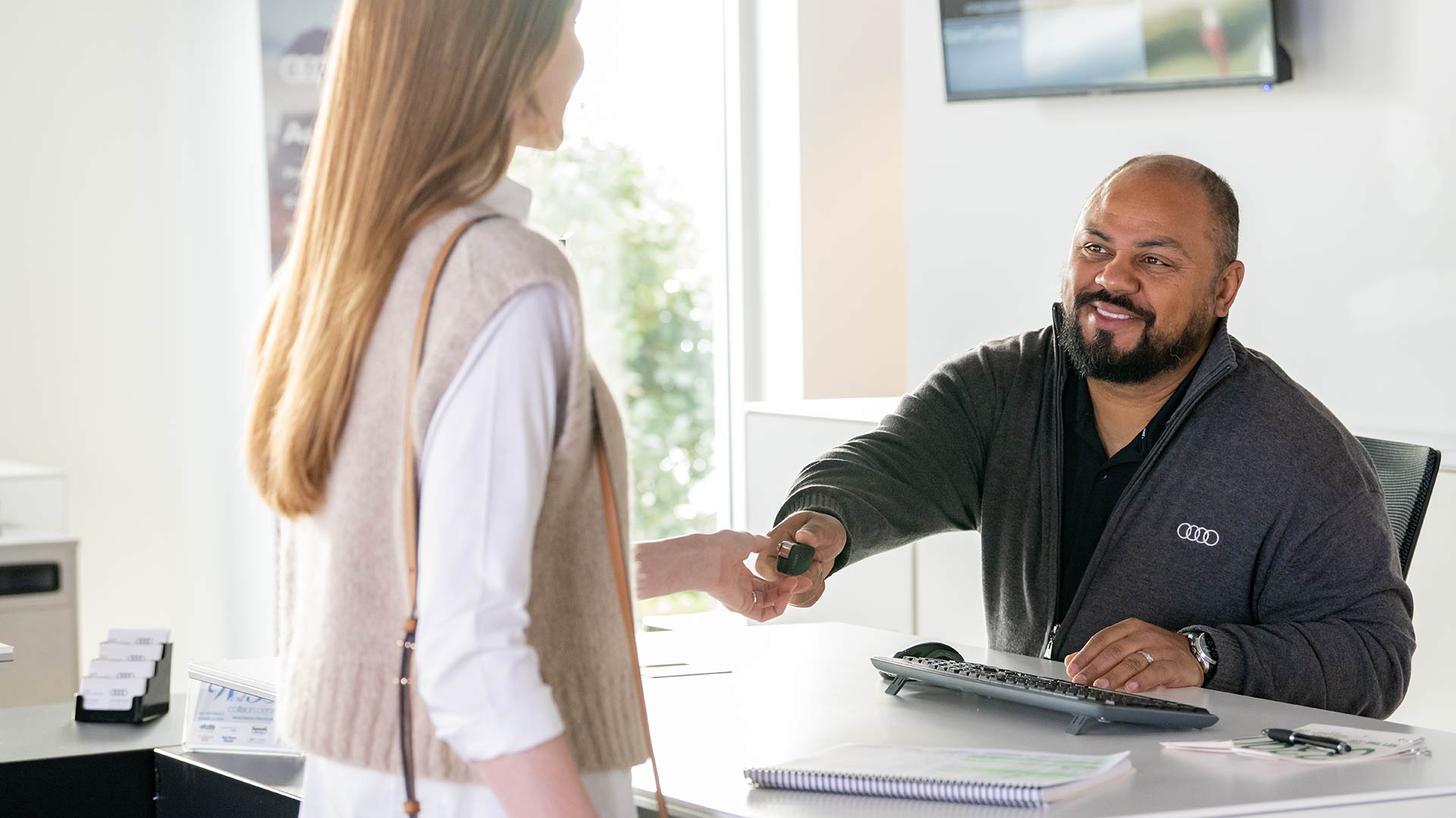 Audi employee handing over keys to customer
