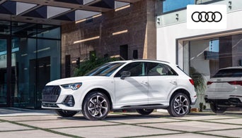 Audi coupe-style SUV with leather seating and touchscreen display. 