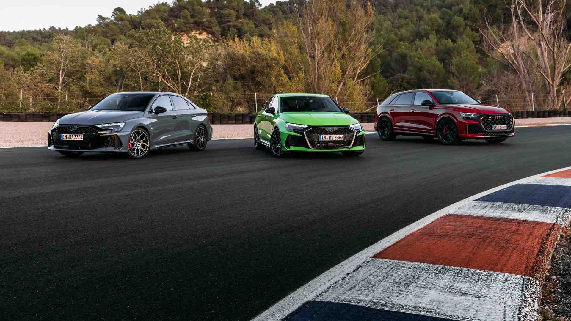 Front profile view of 3 audi RS vehicles parked.