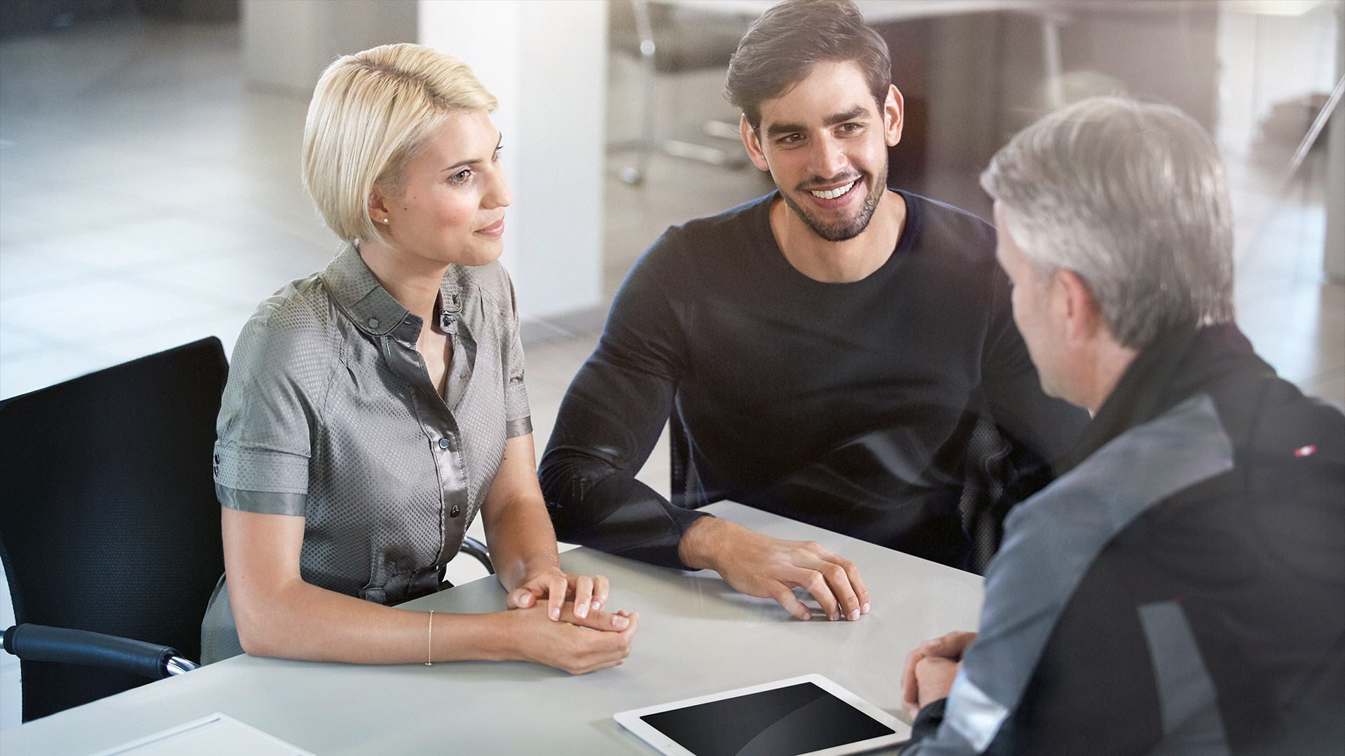 Image of people meeting in an Audi dealership. 