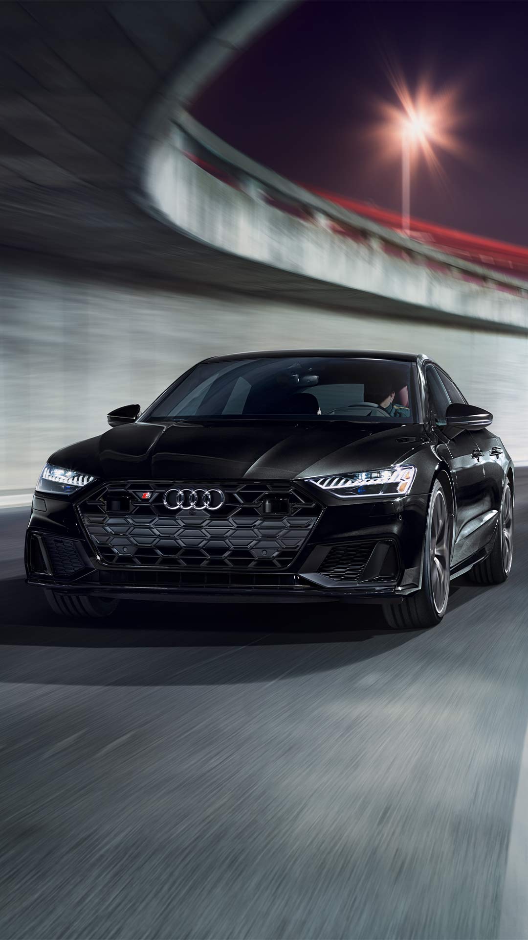 Front view of a black Audi sedan accelerating