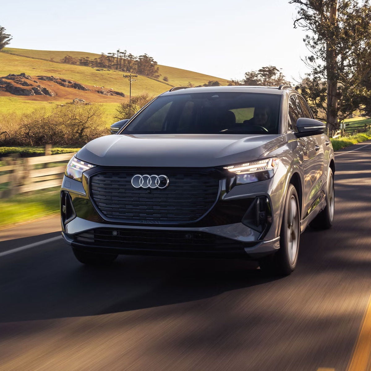 Audi in motion driving down the road