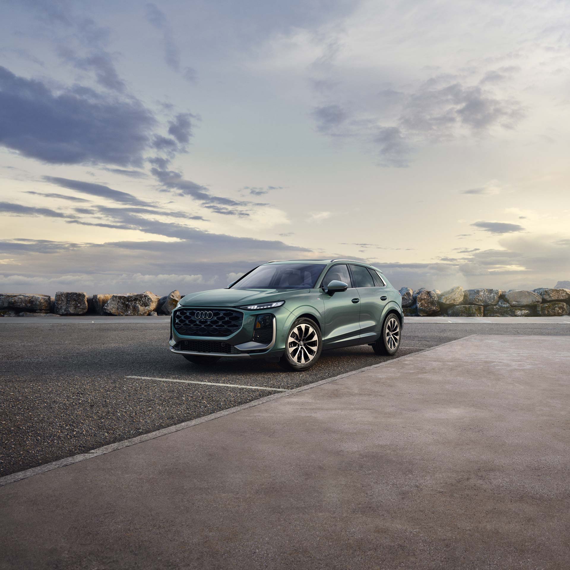 Front profile of the Audi Q6 e-tron in shadow.