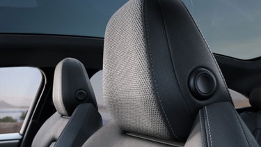 Close-up of the Bang & Olufsen® speakers in the headrest in the Audi A6 Sportback e-tron.